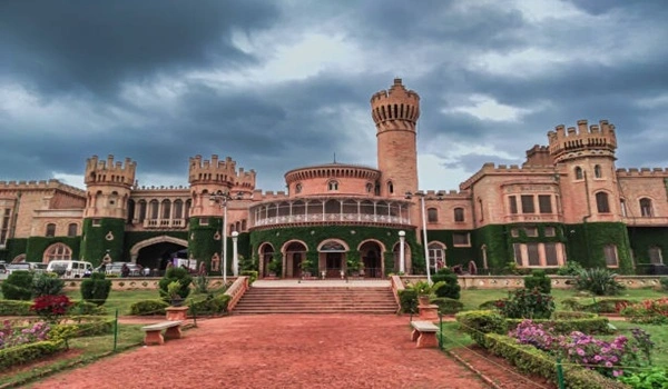 Majestic view of Bangalore Palace with stunning architecture and lush green surroundings in daylight
